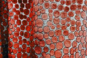 Detailed close up view on samples of cloth and fabrics in different colors found at a fabrics market photo