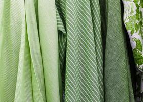 Detailed close up view on samples of cloth and fabrics in different colors found at a fabrics market photo