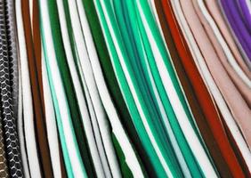 Detailed close up view on samples of cloth and fabrics in different colors found at a fabrics market photo