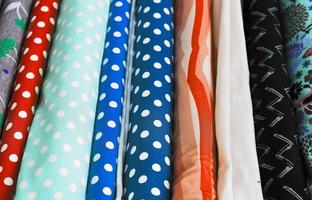 Detailed close up view on samples of cloth and fabrics in different colors found at a fabrics market photo