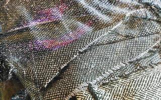 Detailed close up view on samples of cloth and fabrics in different colors found at a fabrics market photo