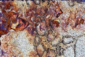 Detailed close up surface of rusty metal and asphalt with lots of corrosion in high resolution photo