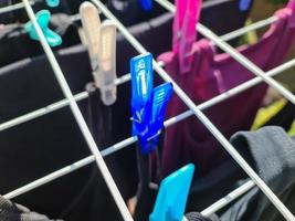 Clothes hung out to dry on a washing line and fastened by the clothes pegs photo