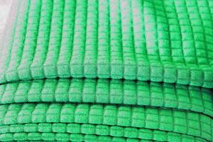 Detailed close up view on samples of cloth and fabrics in different colors found at a fabrics market photo