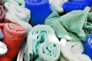Detailed close up view on samples of cloth and fabrics in different colors found at a fabrics market photo
