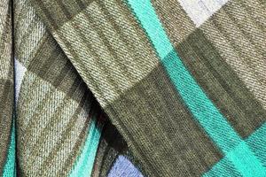 Detailed close up view on samples of cloth and fabrics in different colors found at a fabrics market photo