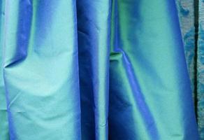 Detailed close up view on samples of cloth and fabrics in different colors found at a fabrics market photo