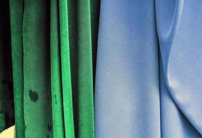 Detailed close up view on samples of cloth and fabrics in different colors found at a fabrics market photo