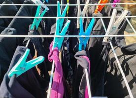 Clothes hung out to dry on a washing line and fastened by the clothes pegs photo