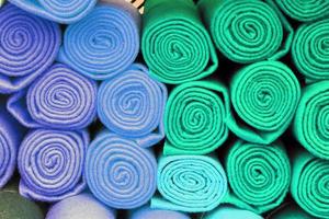 Detailed close up view on samples of cloth and fabrics in different colors found at a fabrics market photo