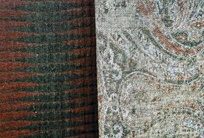 Detailed close up view on samples of cloth and fabrics in different colors found at a fabrics market photo