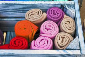 Detailed close up view on samples of cloth and fabrics in different colors found at a fabrics market photo