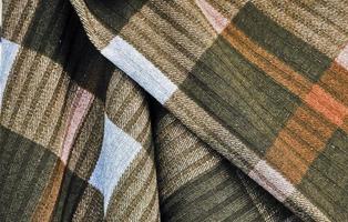 Detailed close up view on samples of cloth and fabrics in different colors found at a fabrics market photo