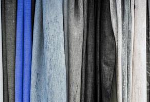 Detailed close up view on samples of cloth and fabrics in different colors found at a fabrics market photo