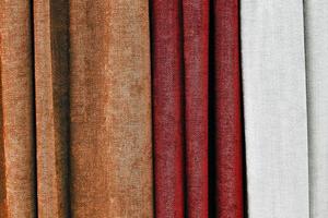 Detailed close up view on samples of cloth and fabrics in different colors found at a fabrics market photo