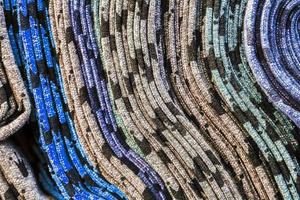 Detailed close up view on samples of cloth and fabrics in different colors found at a fabrics market photo