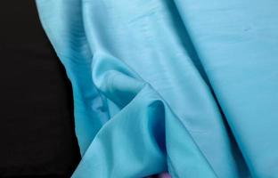 Detailed close up view on samples of cloth and fabrics in different colors found at a fabrics market photo