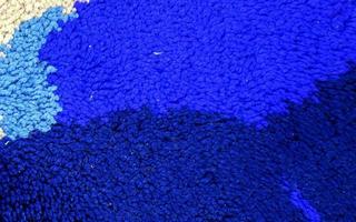Detailed close up view on samples of cloth and fabrics in different colors found at a fabrics market photo