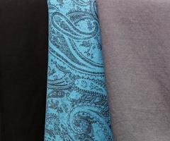 Detailed close up view on samples of cloth and fabrics in different colors found at a fabrics market photo