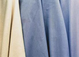 Detailed close up view on samples of cloth and fabrics in different colors found at a fabrics market photo