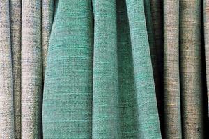 Detailed close up view on samples of cloth and fabrics in different colors found at a fabrics market photo