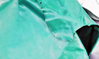 Detailed close up view on samples of cloth and fabrics in different colors found at a fabrics market photo