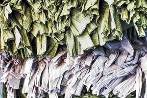 Detailed close up view on samples of cloth and fabrics in different colors found at a fabrics market photo