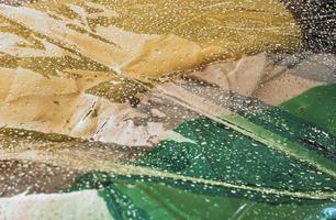 Detailed close up view on samples of cloth and fabrics in different colors found at a fabrics market photo