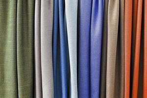Detailed close up view on samples of cloth and fabrics in different colors found at a fabrics market photo