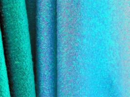 Detailed close up view on samples of cloth and fabrics in different colors found at a fabrics market photo