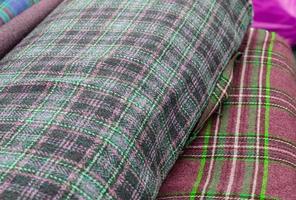 Detailed close up view on samples of cloth and fabrics in different colors found at a fabrics market photo