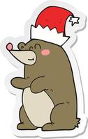 sticker of a cartoon bear wearing christmas hat vector