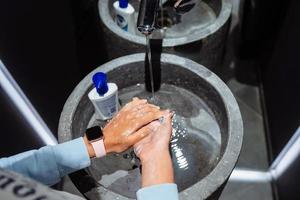 Man washing hands to protect against the coronavirus photo