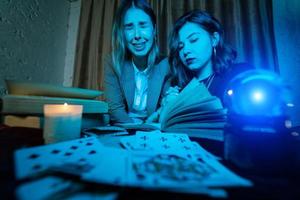 Two women are reading a mysterious book photo