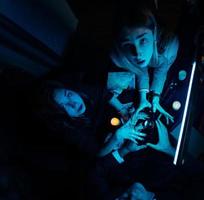 Group of people and woman fortune teller with crystal ball photo