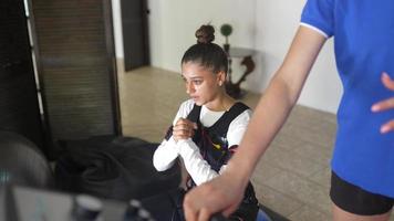 EMS training. Girl doing exercises in a suit with cables. photo