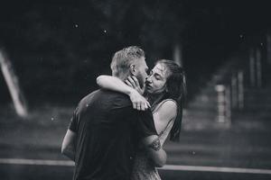 beautiful couple kissing  in the rain photo