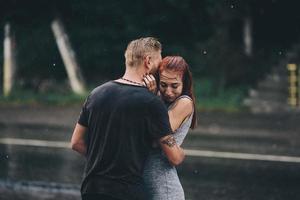 beautiful couple hugging in the rain photo