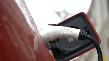 An electric car charging at a power station photo