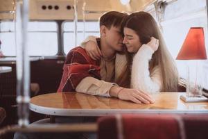 Loving young couple in winter time sitting in a cafe photo