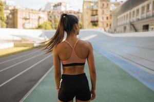 A young beautiful dark-haired athletic girl, warming up photo