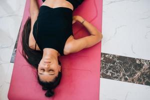 Young woman practicing in a yoga studio. photo