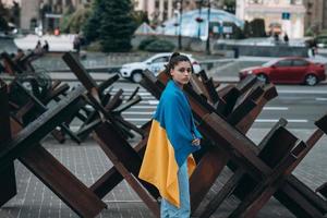 Young woman covered with the Ukrainian flag photo