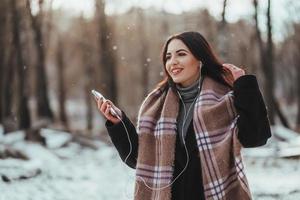 Woman listening music with her mobile phone photo