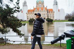 Young girl in Mash Park against the background of the New Town Hall photo