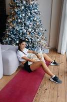 Girl posing against the backdrop of Christmas decor. photo