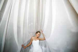 Beautiful bride posing in daylight photo