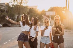 cuatro mujeres jóvenes tomándose un selfie y divirtiéndose foto