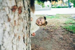 Cute little girl is playing outdoors photo