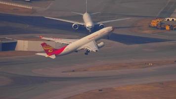 HONG KONG NOVEMBER 10, 2019 - Hong Kong Airlines Airbus A330 airliner climbing up in the air right after take off from Chek Lap Kok international airport, Hong Kong. video